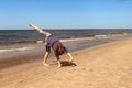 Teenage girl doing a cartwheel on a beach in Latvia Royalty Free Stock Photo