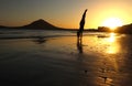 Girl doing handstand on beach at sunset in Tenerife, Spain Royalty Free Stock Photo
