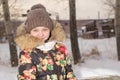 A teenage girl in a down jacket in winter, ice skating, Royalty Free Stock Photo