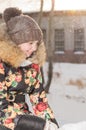 A teenage girl in a down jacket in winter, ice skating, Royalty Free Stock Photo