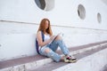 teenage girl draws in the sketchbook while sitting on the steps Royalty Free Stock Photo