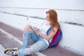 teenage girl draws in the sketchbook while sitting on the steps Royalty Free Stock Photo