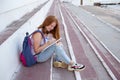 teenage girl draws in the sketchbook while sitting on the steps Royalty Free Stock Photo