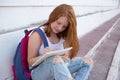 teenage girl draws in the sketchbook while sitting on the steps Royalty Free Stock Photo