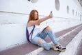 teenage girl draws in the sketchbook while sitting on the steps Royalty Free Stock Photo