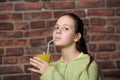 Teenage girl drinking orange juice Royalty Free Stock Photo