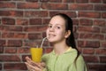 Teenage girl drinking orange juice Royalty Free Stock Photo