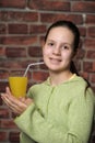 Teenage girl drinking orange juice Royalty Free Stock Photo