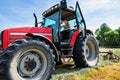 young woman in tractor turning hay in pasture Royalty Free Stock Photo