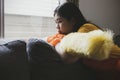 Lazy teenage woman doing housework and alone in the house sitting on the sofa quietly. Royalty Free Stock Photo