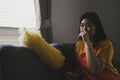 Lazy teenage woman doing housework and alone in the house sitting on the sofa quietly. Royalty Free Stock Photo