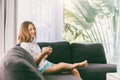 Teenage girl eating brekfast on couch in living room Royalty Free Stock Photo