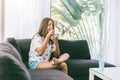 Teenage girl eating brekfast on couch in living room Royalty Free Stock Photo