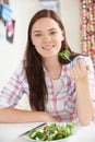 Teenage Girl At Home Eating Healthy Plate Of Salad Royalty Free Stock Photo