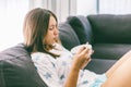 Teenage girl eating brekfast on couch in living room Royalty Free Stock Photo