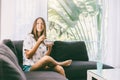 Teenage girl eating brekfast on couch in living room Royalty Free Stock Photo