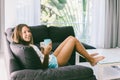 Teenage girl eating brekfast on couch in living room Royalty Free Stock Photo