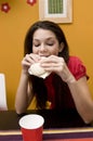 Teenage girl eating a sandwich