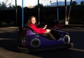 Teenage girl in an electric bumper car Royalty Free Stock Photo