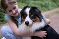 teenage girl embrace australian shepherd dog in summer. Stand in forest Royalty Free Stock Photo