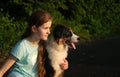 teenage girl embrace australian shepherd puppy dog in summer. in forest Royalty Free Stock Photo