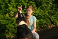 teenage girl embrace australian shepherd puppy dog in summer. in forest Royalty Free Stock Photo