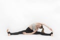 Teenage girl is engaged in gymnastics. Dancer in training on white background. Exercise to develop flexibility Royalty Free Stock Photo