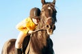 Teenage girl equestrian riding horseback ready to jump. Vibrant