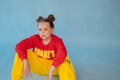 teenage girl in fashion stylish bright clothes. little lady in red and yellow on blue background. makeup and hairdo Royalty Free Stock Photo