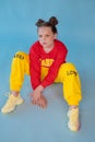 teenage girl in fashion stylish bright clothes. little lady in red and yellow on blue background. makeup and hairdo Royalty Free Stock Photo