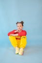 teenage girl in fashion stylish bright clothes. little lady in red and yellow on blue background. makeup and hairdo Royalty Free Stock Photo