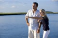 Teenage girl and father standing by water watching Royalty Free Stock Photo