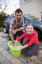 Teenage girl and father washing a car Royalty Free Stock Photo