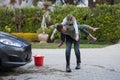 Teenage girl and father washing a car Royalty Free Stock Photo