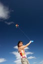 Teenage girl flying a kite Royalty Free Stock Photo