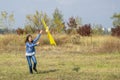 Teenage girl flying a yellow kite. Beautiful young girl kite fly. Happy little girl running with kite in hands on the beautiful Royalty Free Stock Photo