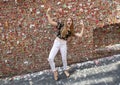 Teenage girl in front of The Market Theater Gum Wall, Pike Place Market, Seattle, Washington