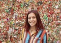 Teenage girl in front of The Market Theater Gum Wall, Pike Place Market, Seattle, Washington