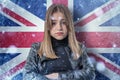 Teenage girl on frozen background with flag of Great Britan. Concept of crisis in Europe in winter. Energy crisis