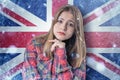 Teenage girl on frozen background with flag of Great Britan. Concept of crisis in Europe in winter. Energy crisis