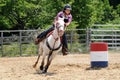 Teenage girl galloping around a turn in a barrel race Royalty Free Stock Photo