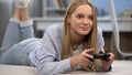 Teenage girl gamer playing shooter with joystick, entertainment, leisure time