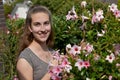 Teenage girl and pink mandevilla