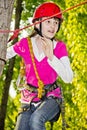 A teenage girl goes on hinged trail in extreme rope park Royalty Free Stock Photo