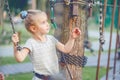 Teenage girl goes on hinged trail in rope park. Royalty Free Stock Photo