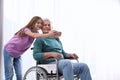 Teenage girl with grandfather in wheelchair taking selfie Royalty Free Stock Photo