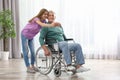 Teenage girl with grandfather in wheelchair taking selfie Royalty Free Stock Photo