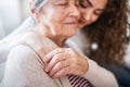 A teenage girl with grandmother at home, hugging. Royalty Free Stock Photo