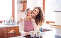 A teenage girl with grandmother at home. Royalty Free Stock Photo