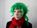 teenage girl with green hair and green eyes in a red scarf, cosplay of the anime character Midori Royalty Free Stock Photo